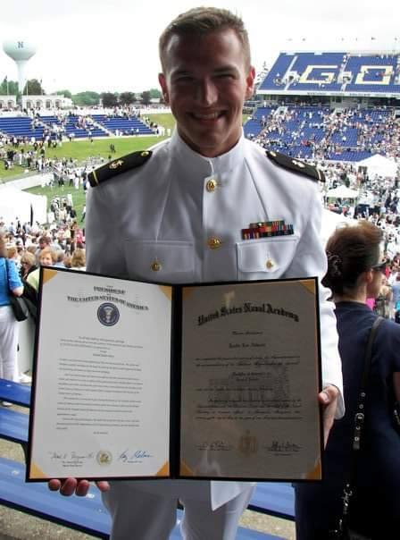 Justin leaning against a bus